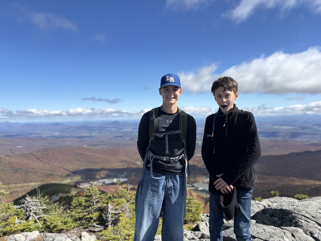 two boys standing at the peak of Jay
