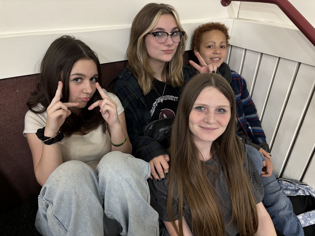 Four 8th grade girls smiling together