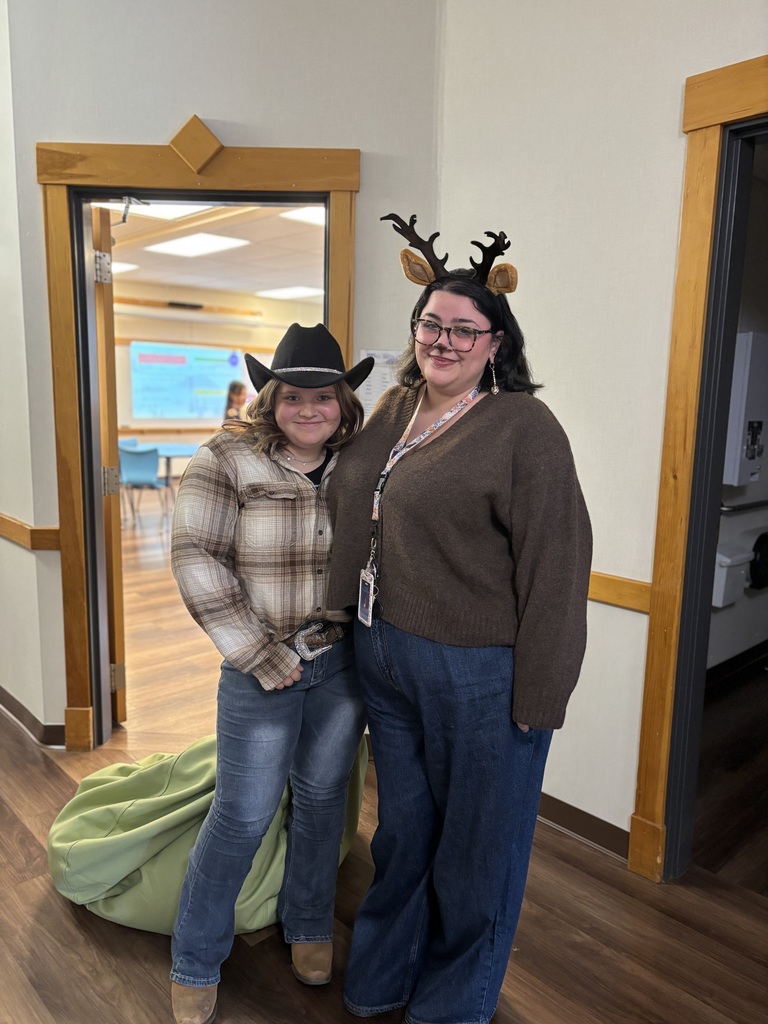 Our school counselor dressed as a deer and a 7th grade student dressed as a cowgirl posing together.