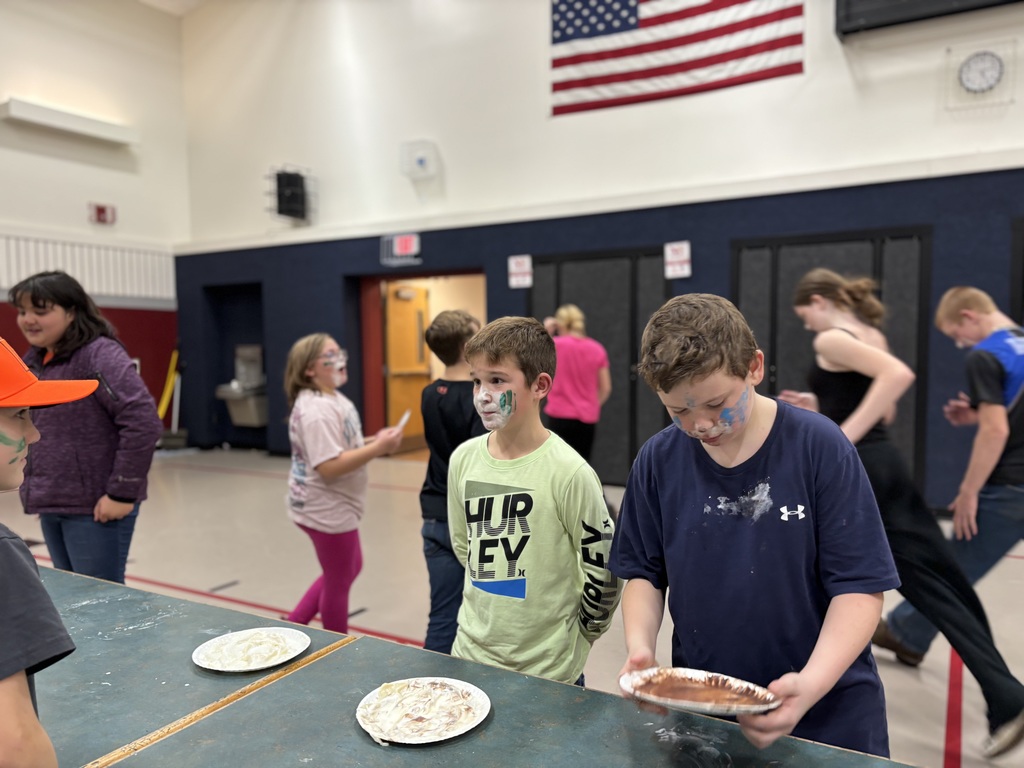 a 5th and 7th grade boy competing in a whipped cream eating contest