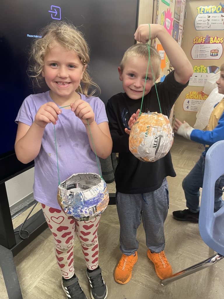 students showing off their paper mache lanterns