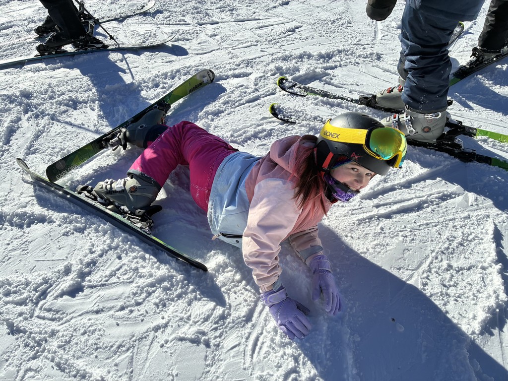a beginner skier who has fallen over and smiling away.