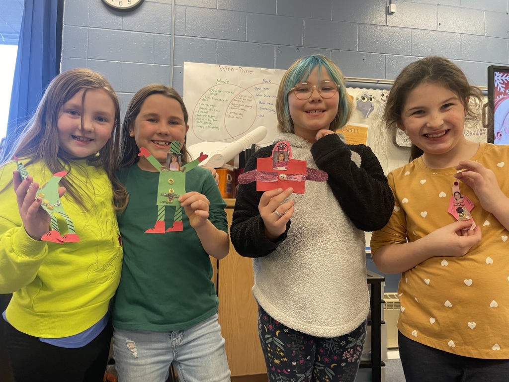 students posing for a photo with their handmade craft 