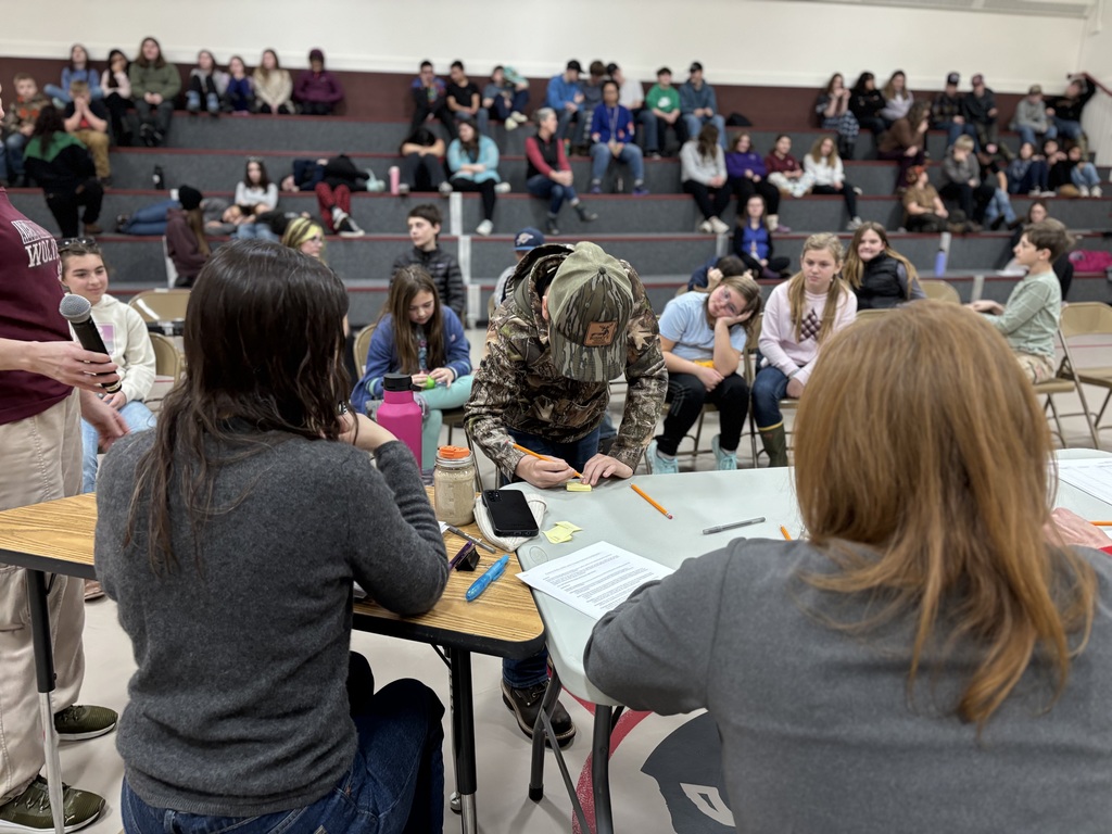 A 5th grade student writes his answer out for the judges before he spells it out loud. 