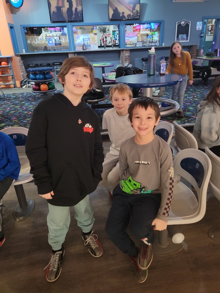 students posing at bowling alley for winter activities 