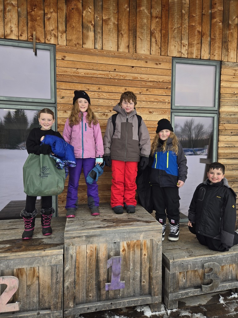 students posing at Craftsbury Outdoor Center after cross country skiing 