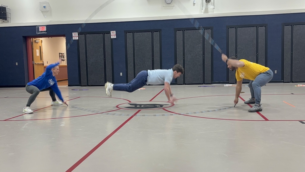 Mr. Verge does jumping push ups while Nick and Kaylee from Learnin' the Ropes moves their jump ropes over him