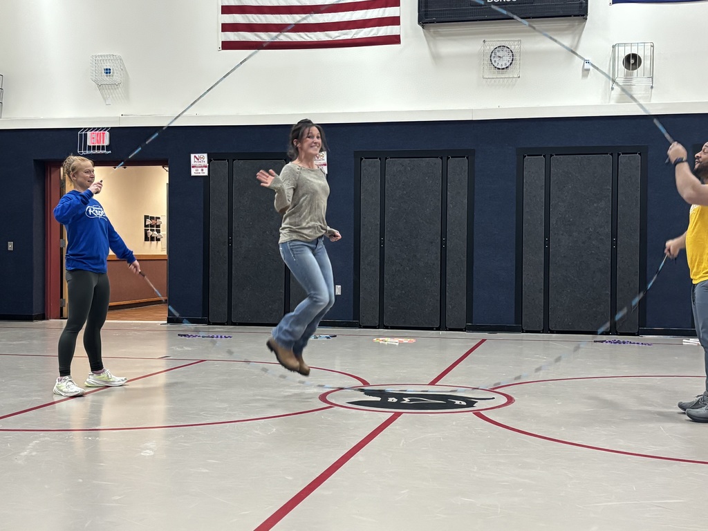 Ms. Angelee jumps rope and smiles and waves while Nick and Kaylee from Learnin' the Ropes uses their jump ropes with her