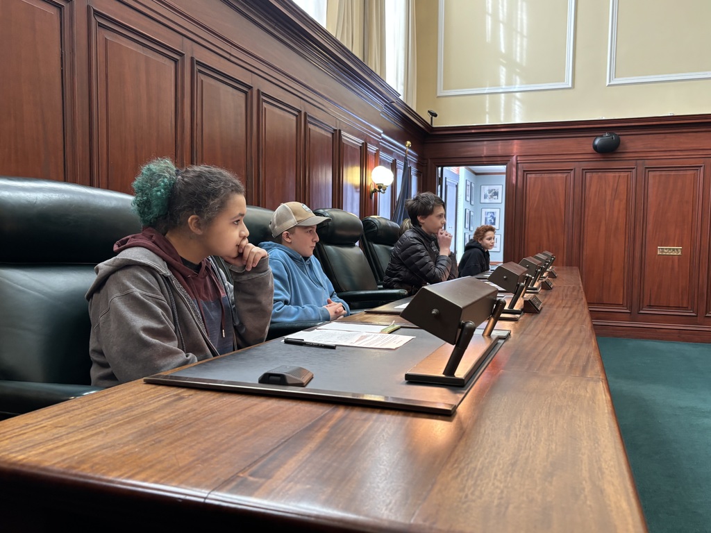8th grade students sit in the chairs of the supreme court's justices and act as the justices for their mock trial 