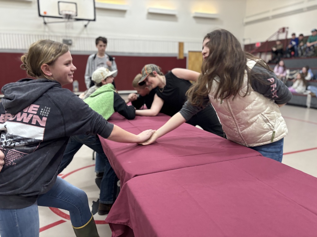 Two 5th grade girls arm wrestling 