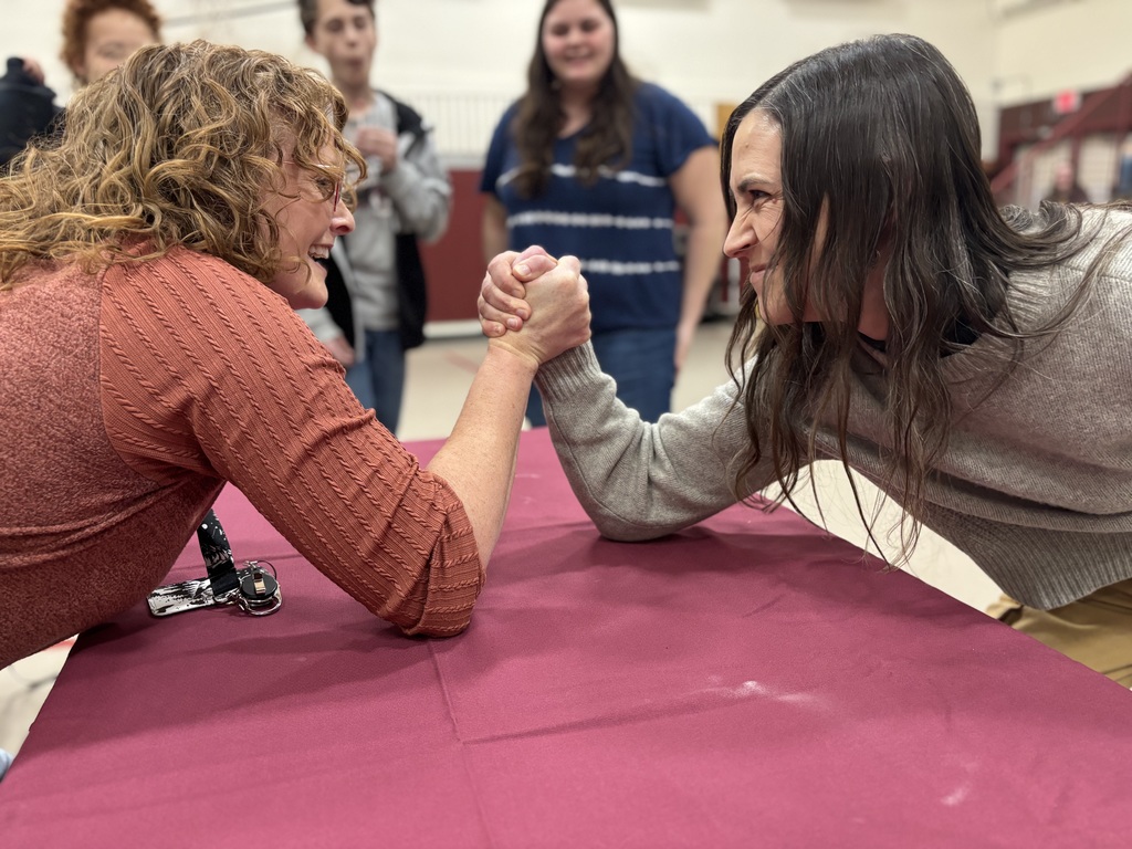 Two teachers arm wrestling 