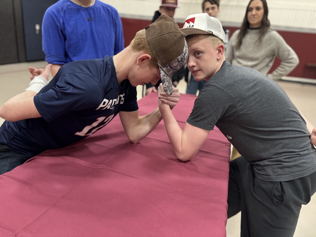 Two 8th grades arm wrestling 