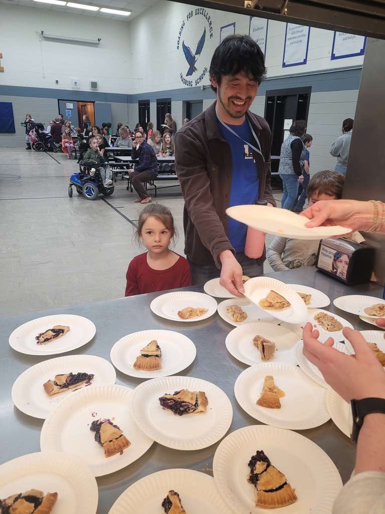 students and teacher in line for pie 