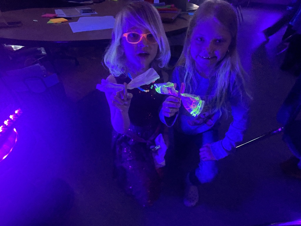 students with their  blacklight butterfly craft 
