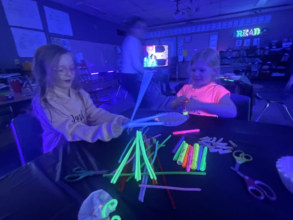 students at black light crafting station 