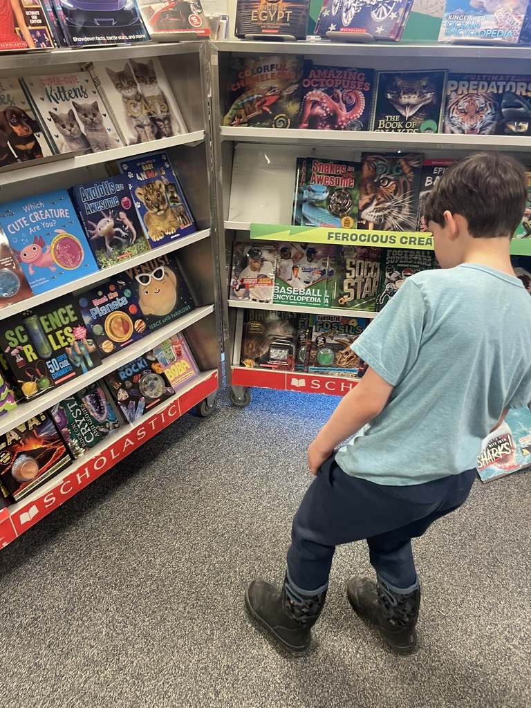 student looking at book fair books