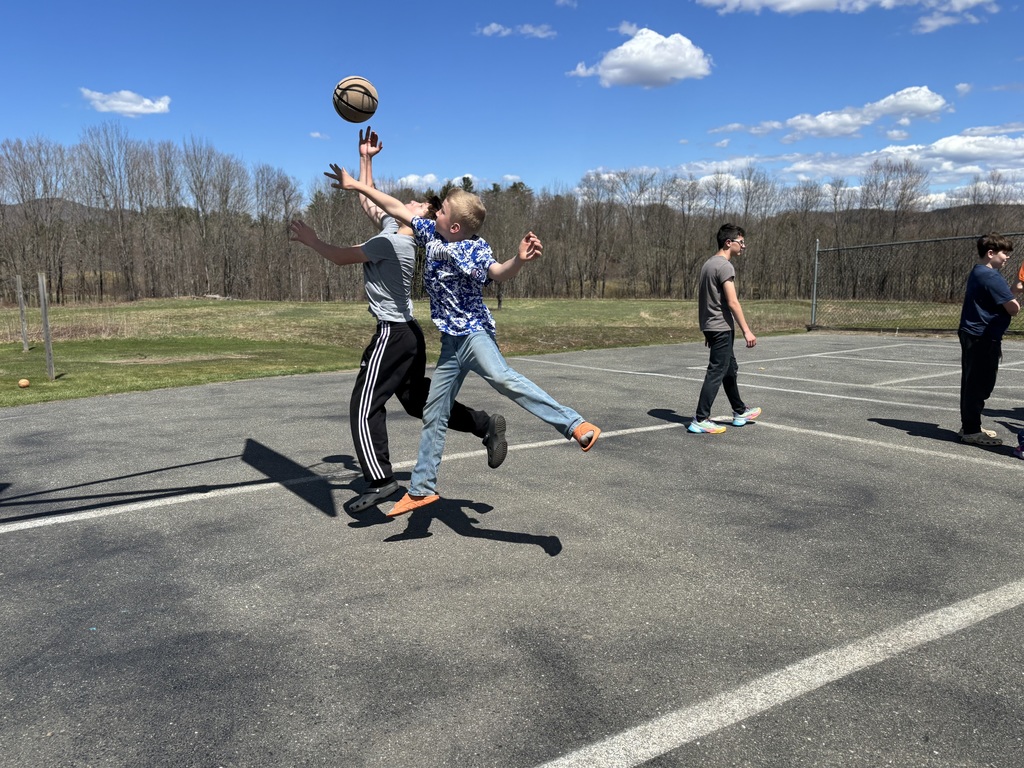 a 5th grade and a 7th grade boy playing basketball