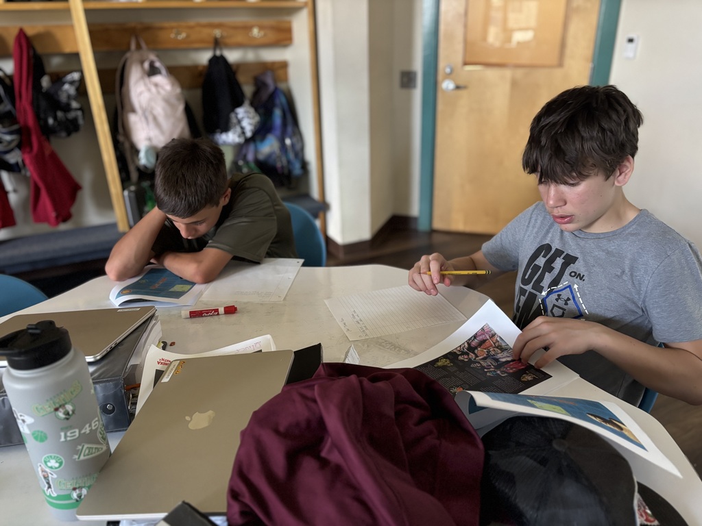 two 7th grade boys are working on classwork in social studies