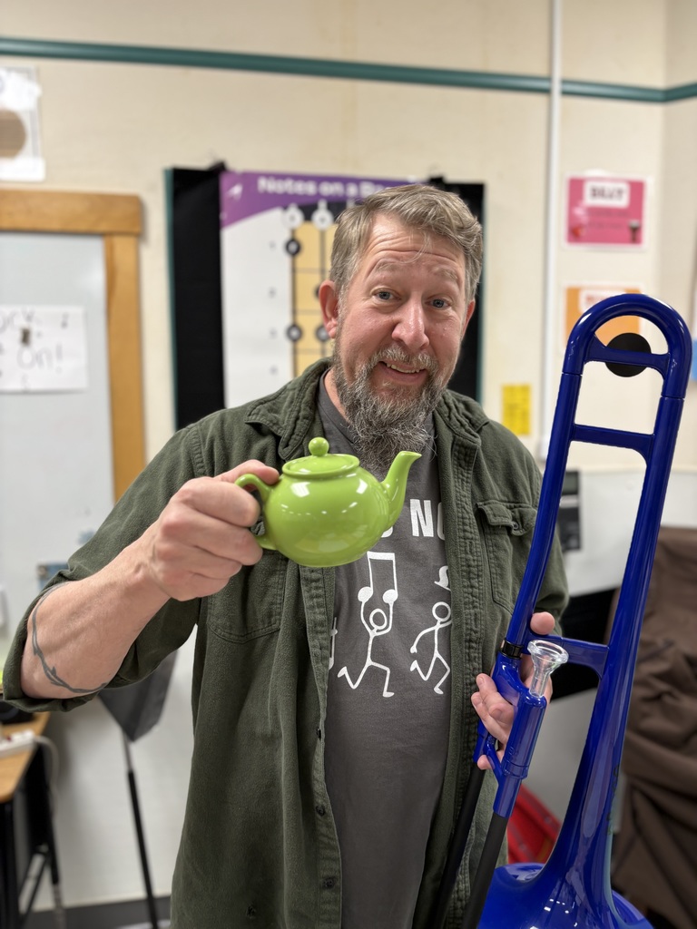 Mr. Dan holds a tea kettle and a trumpet