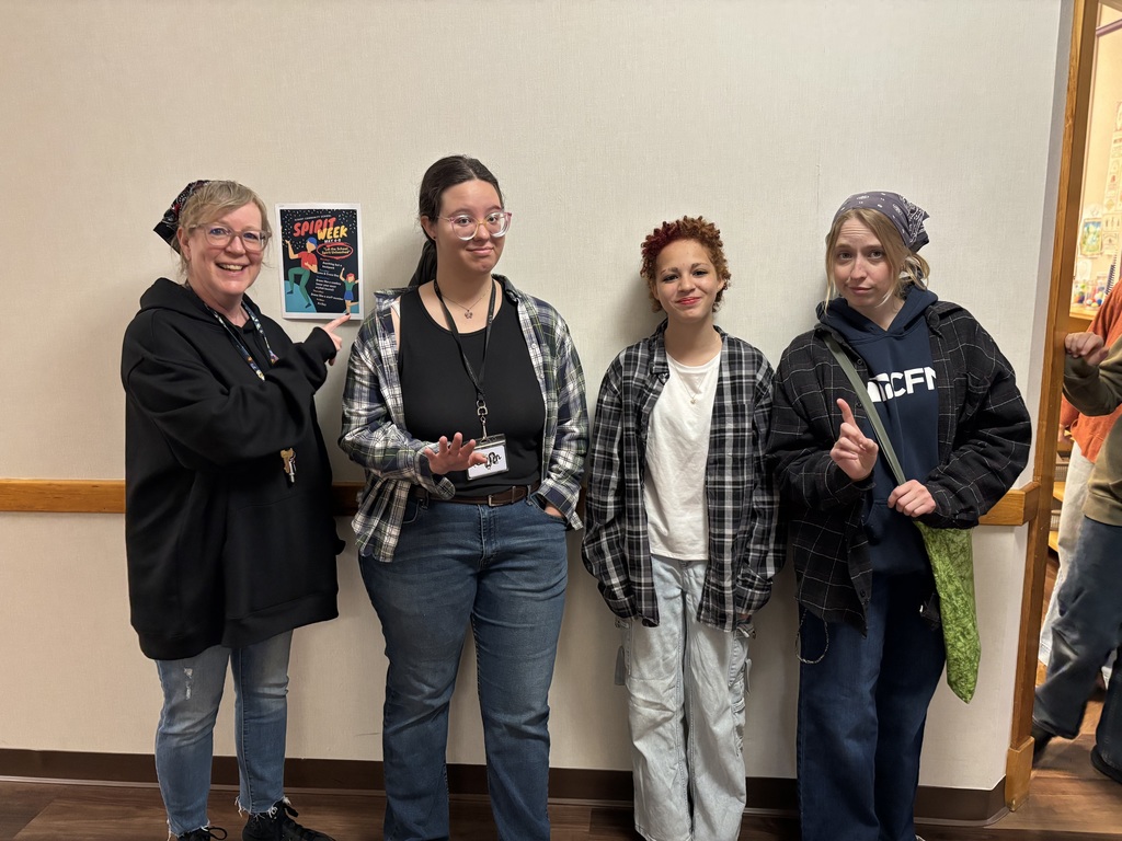 Three staff members (Ms. Wendy, Ms. Rachel, and Ms. Lillis) posing with an 8th grade girl who they dressed as