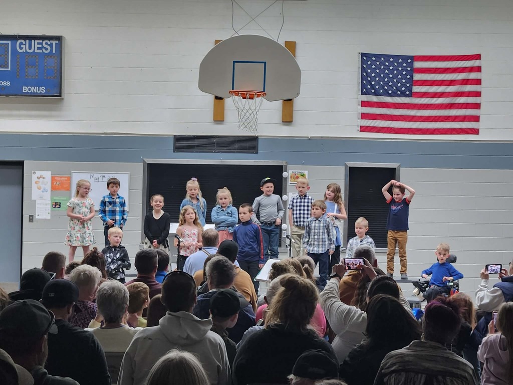 students performing songs on the riser in front of audience 