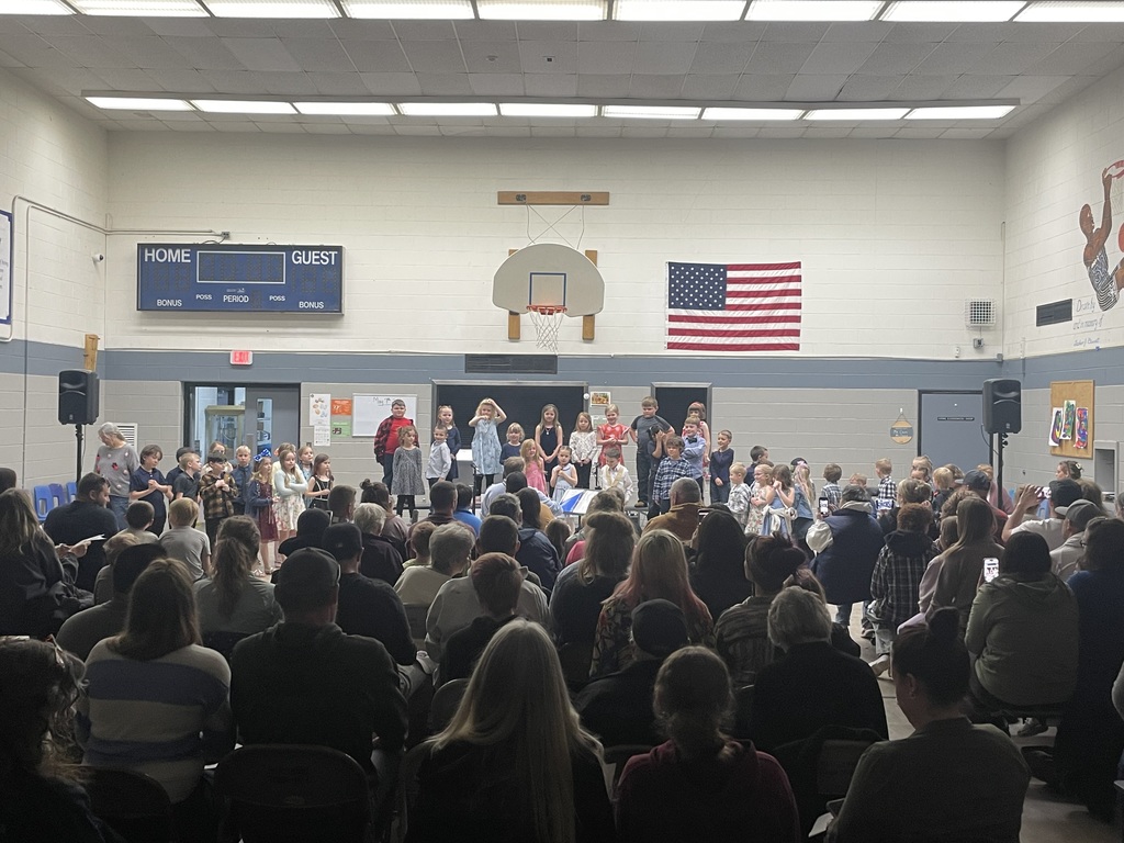 students performing songs on the riser in front of audience 