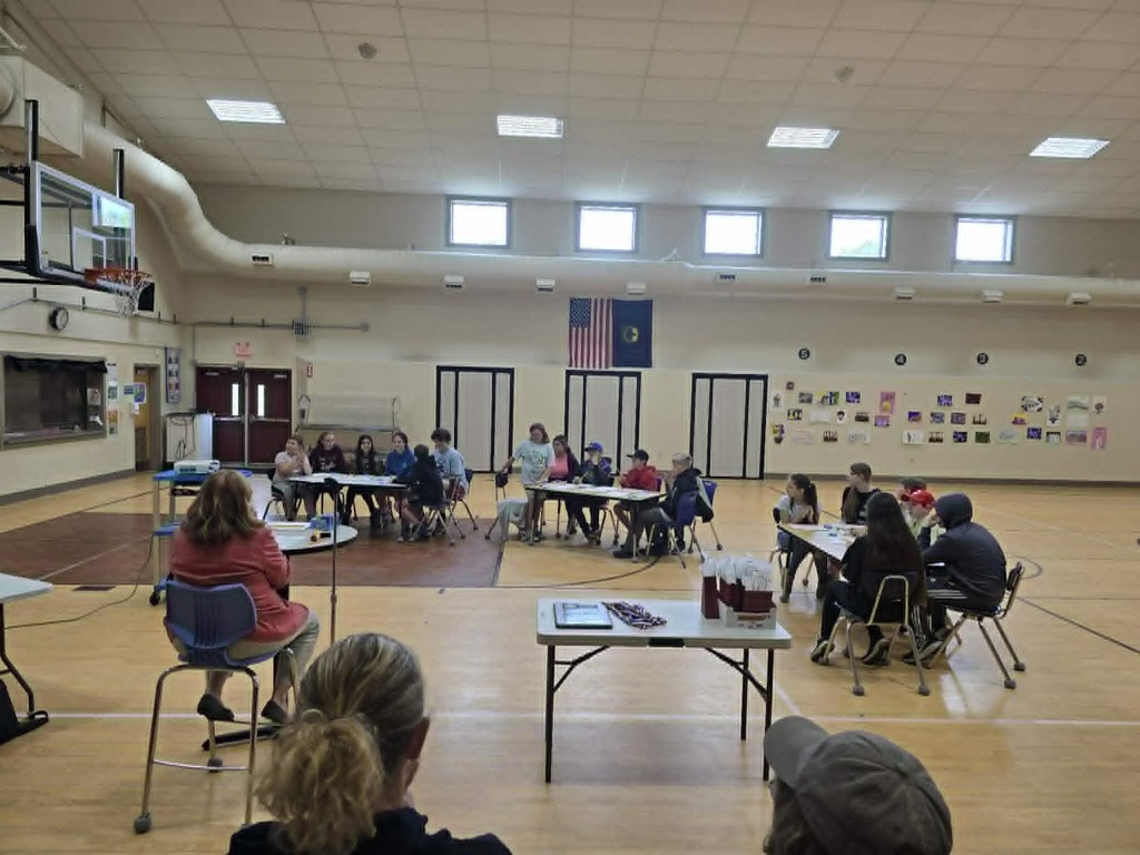 Students at tables competing in the Math Olympiads