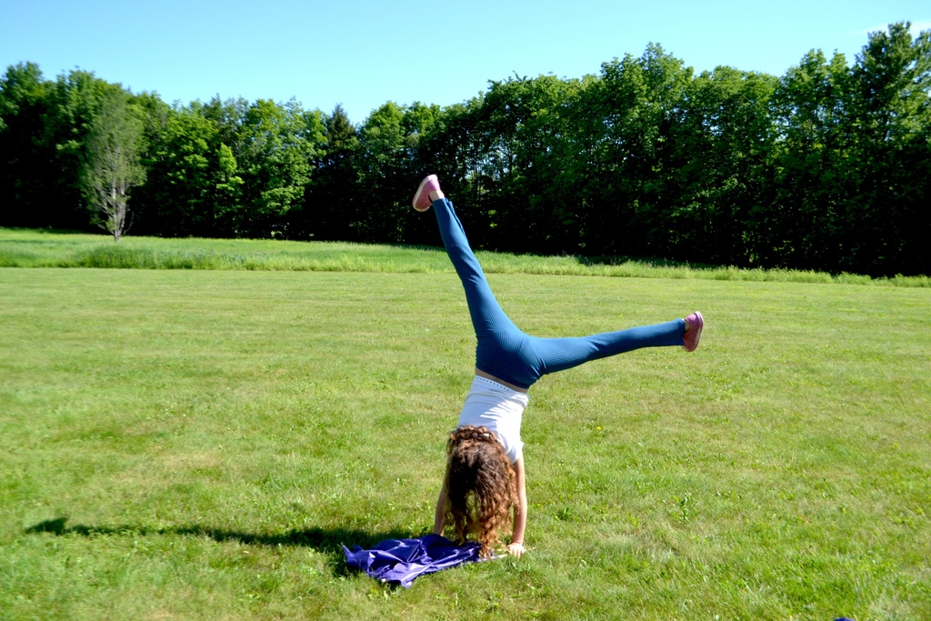 a 5th grade girl does a cartwheel