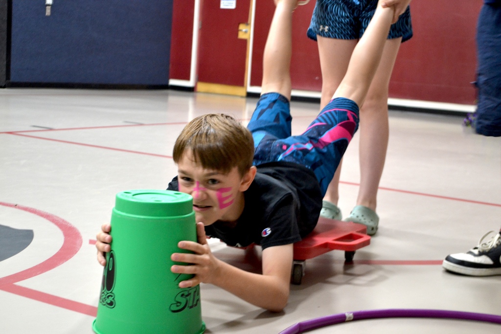 a determined 5th grade boy tries to get some balls in hungry hungry hippo (life size version)