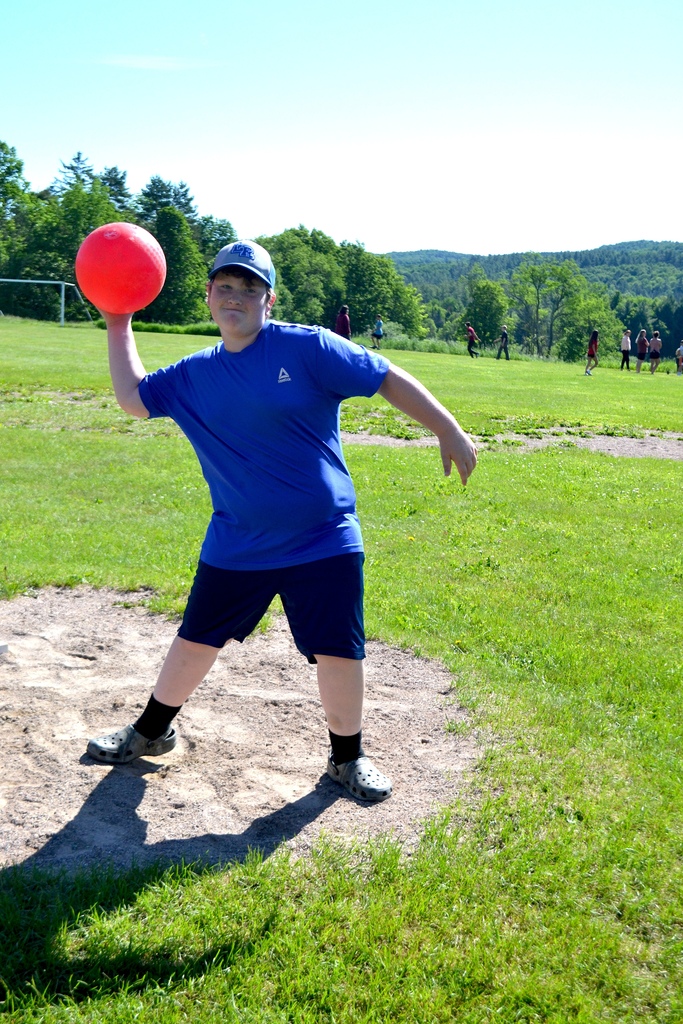 a 6th grade boy gets ready to throw a kickball