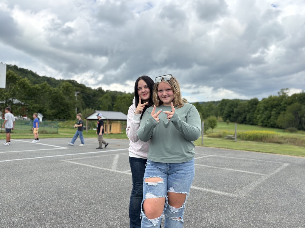 two 8th grade girls pose for the camera