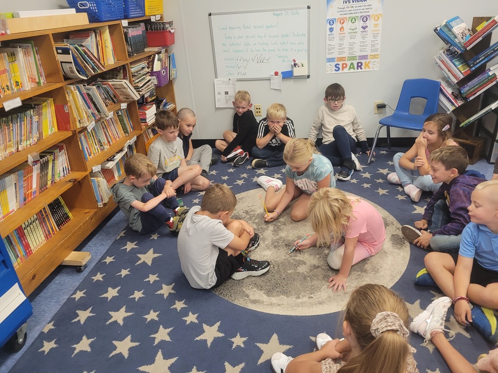 students on classroom rug