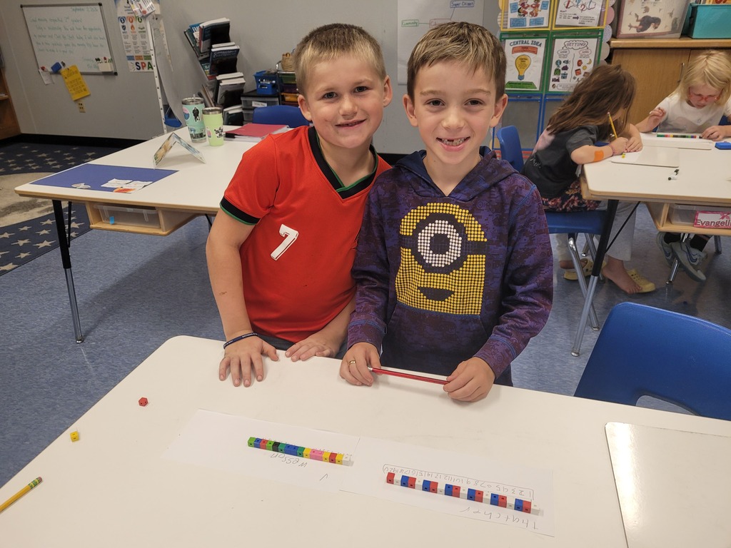 students smiling while working with math manipulatives