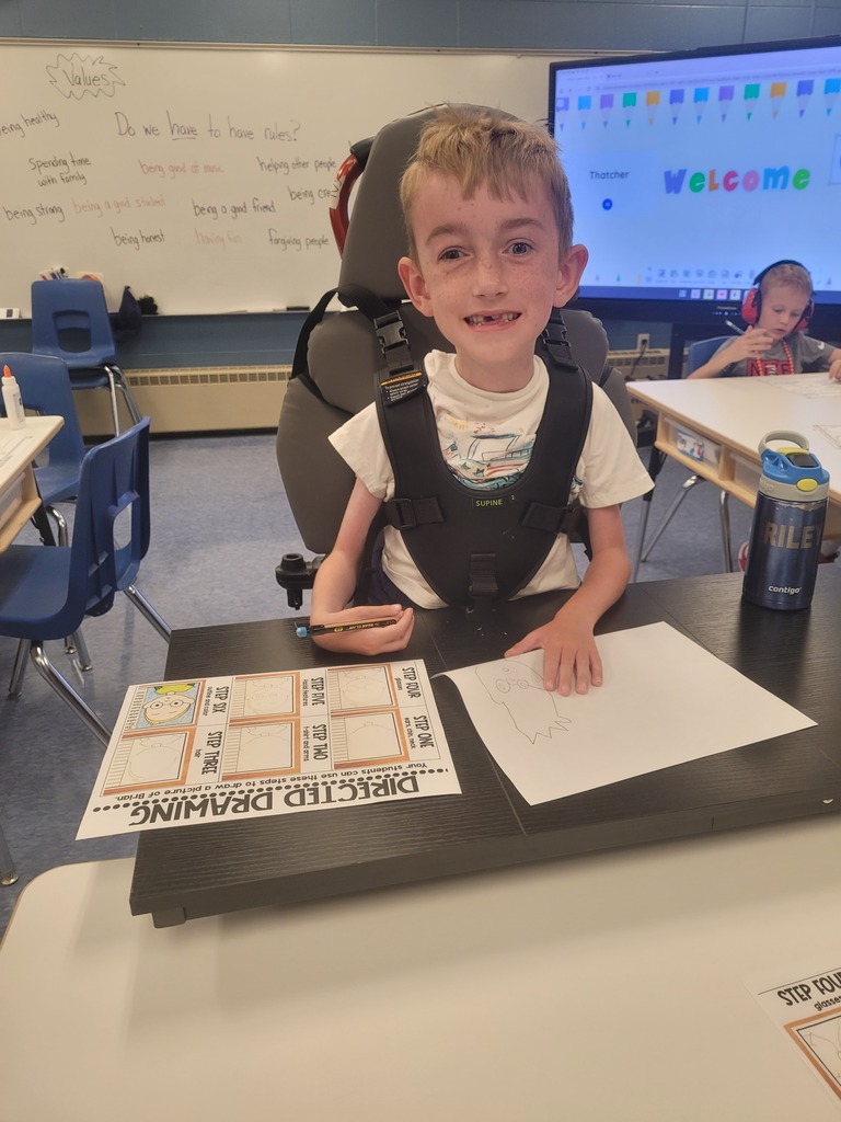 student smiling while doing their work