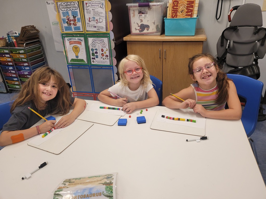 students smiling while doing their work
