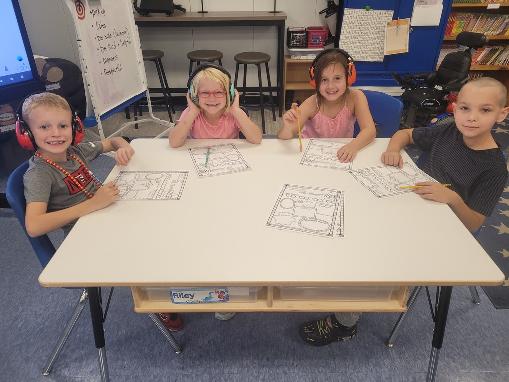 students smiling while doing their work