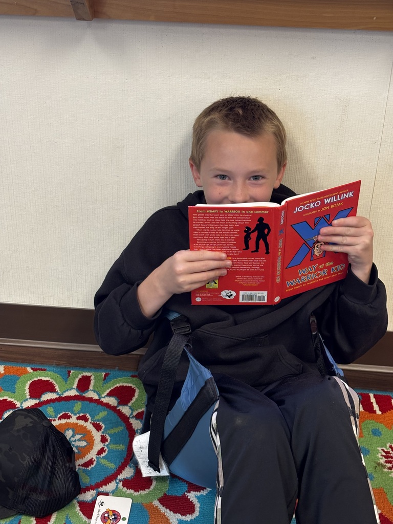 A 5th grade boy reading a book