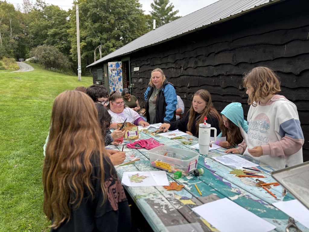 A group of students do arts and crafts outside at Hosmer Point Camp