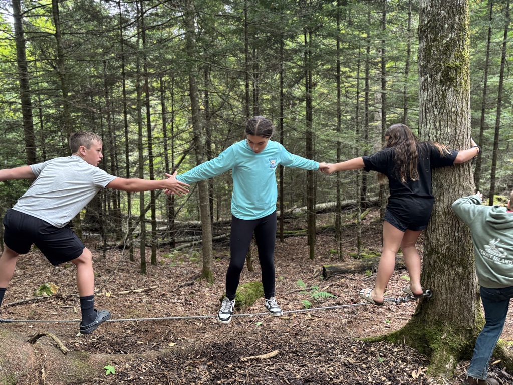 Students work together on a rope course 