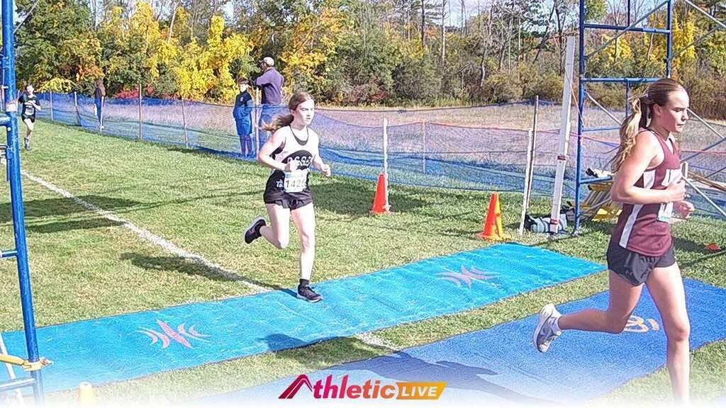 A student running across the finish line. 