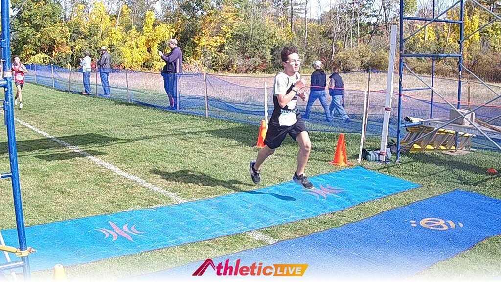 Student running across the finish line