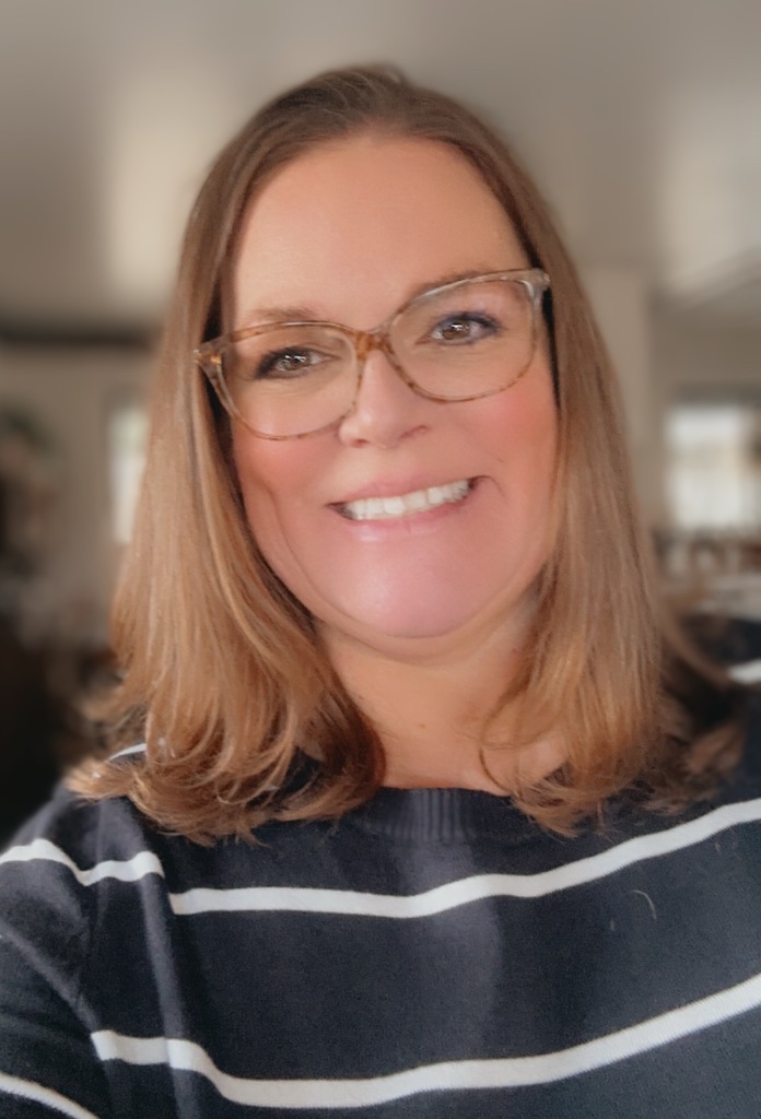 Kristi Anglin selfie in a blue stripped shirt.