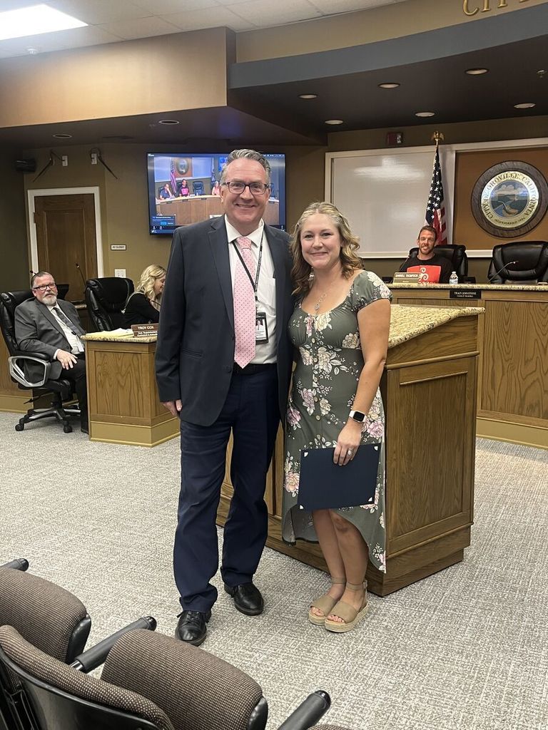 Picture of Dr. Holtom with Ms. Perez at the board meeting