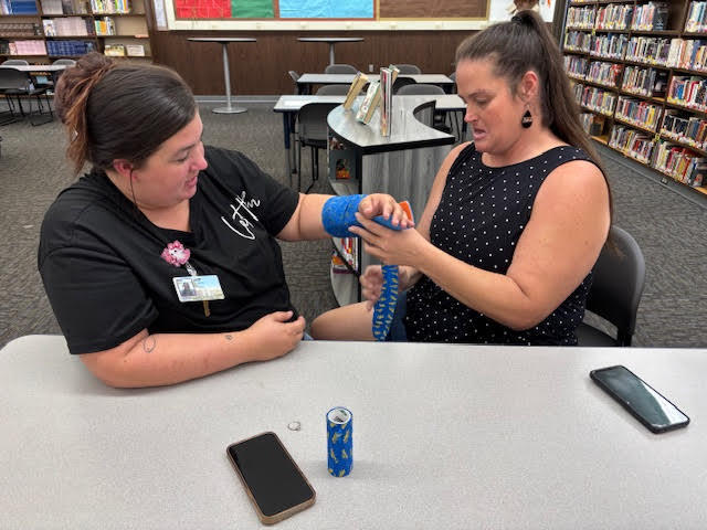 Staff practicing splinting arms