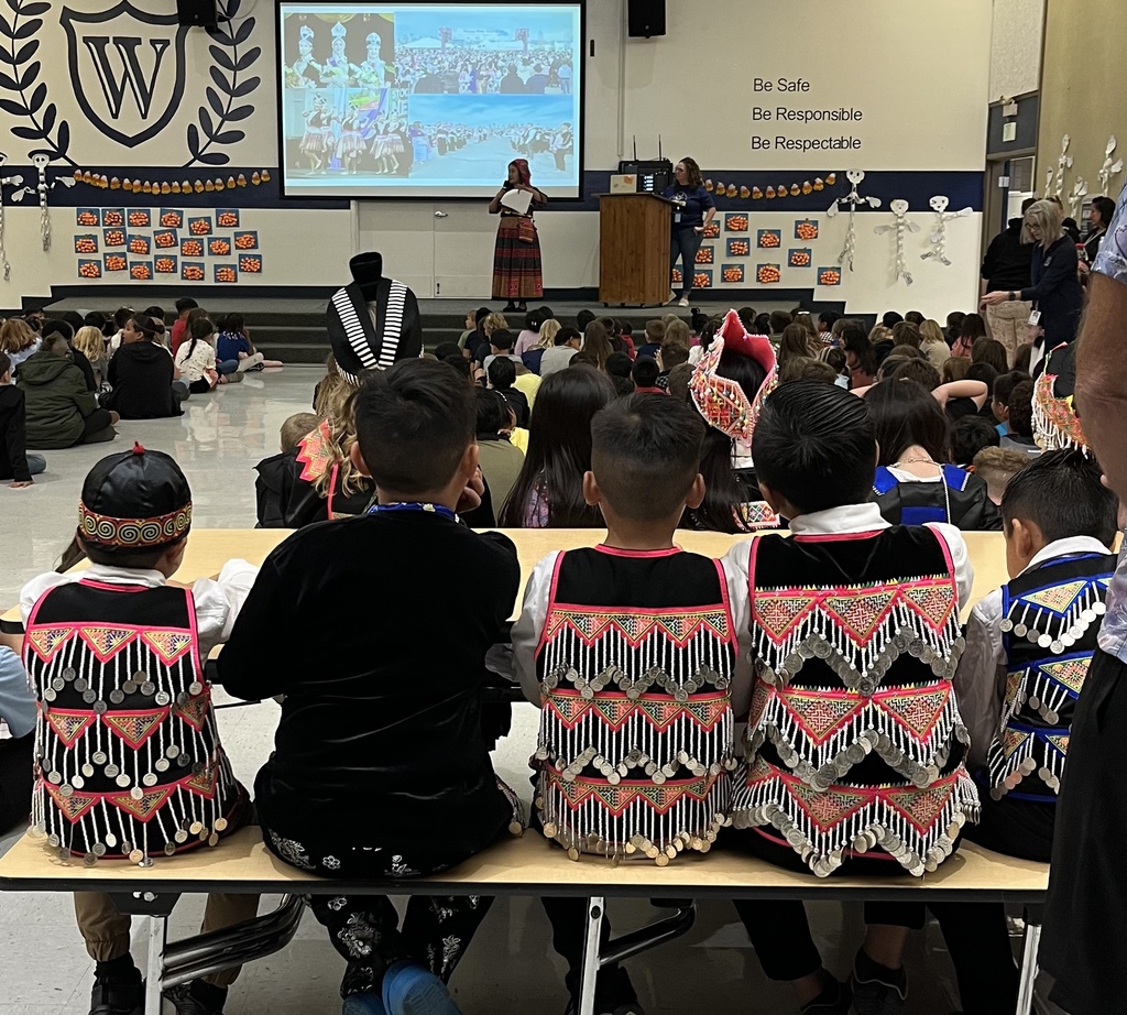 Students in Hmong Attire watching a presentation.