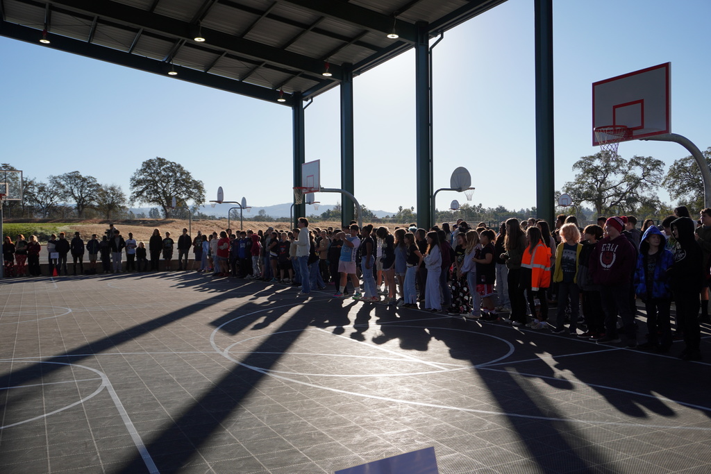 students standing up to watch the presentation 