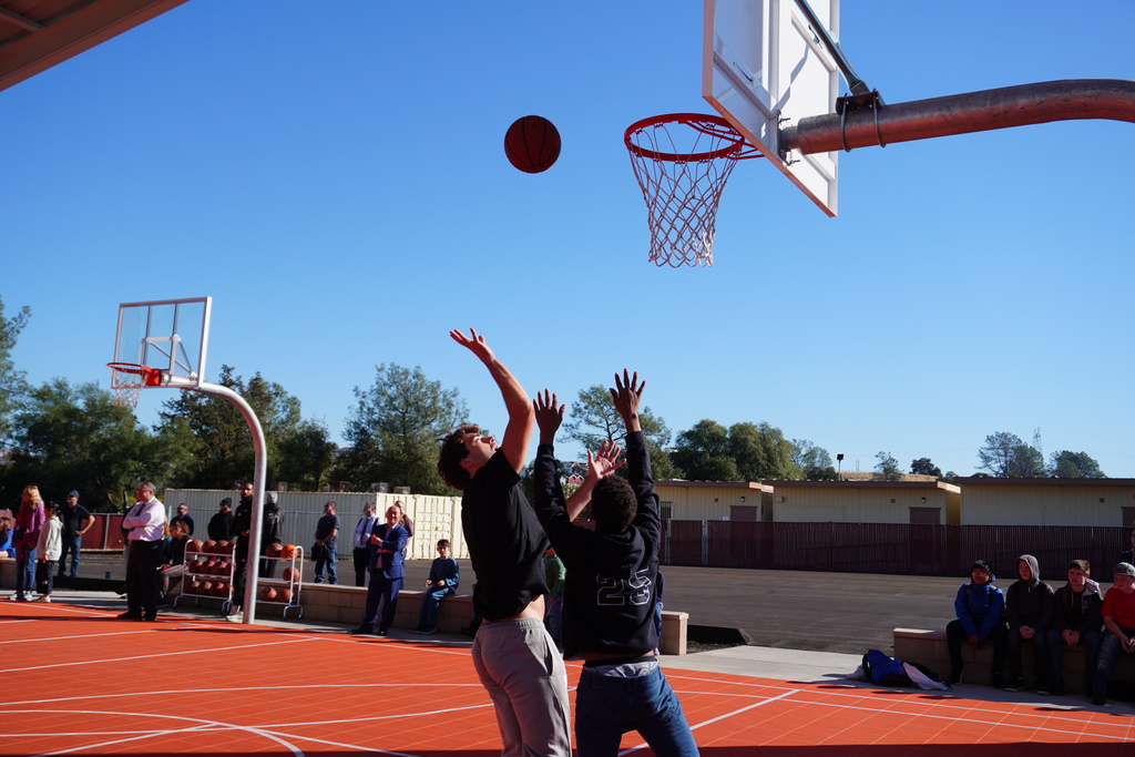 students shooting some baskets