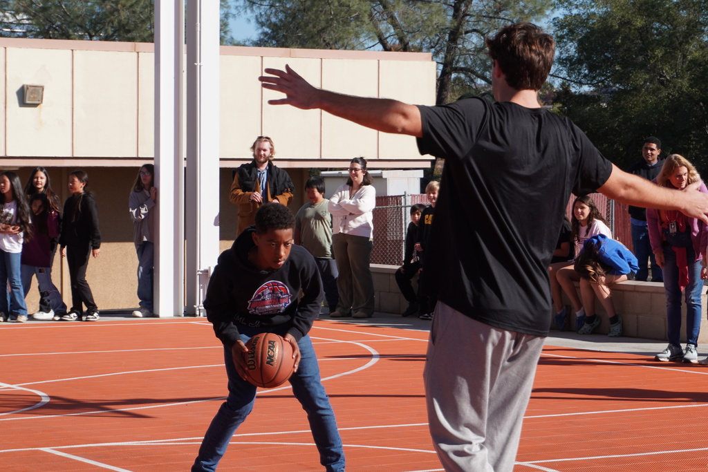 students shooting some baskets