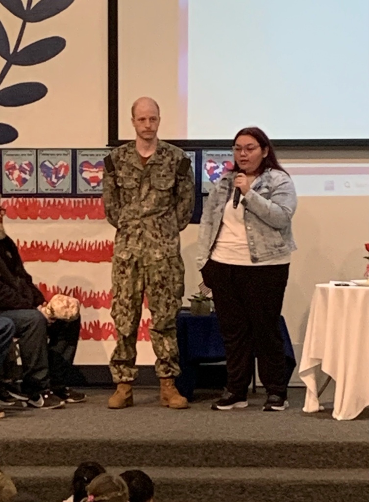 a veteran standing by a staff member