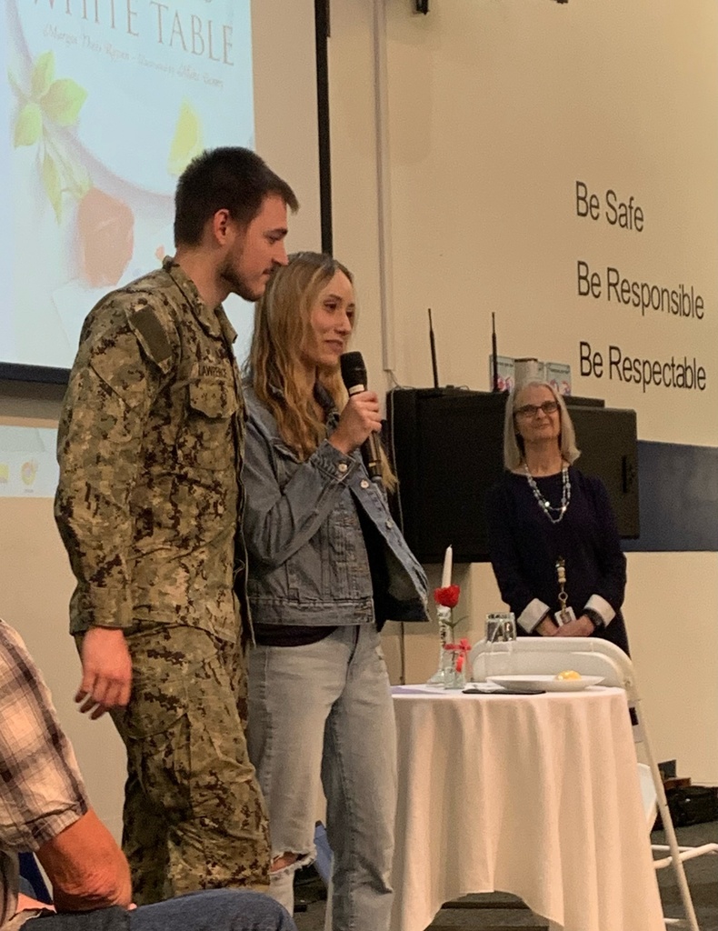 a veteran standing by a staff member